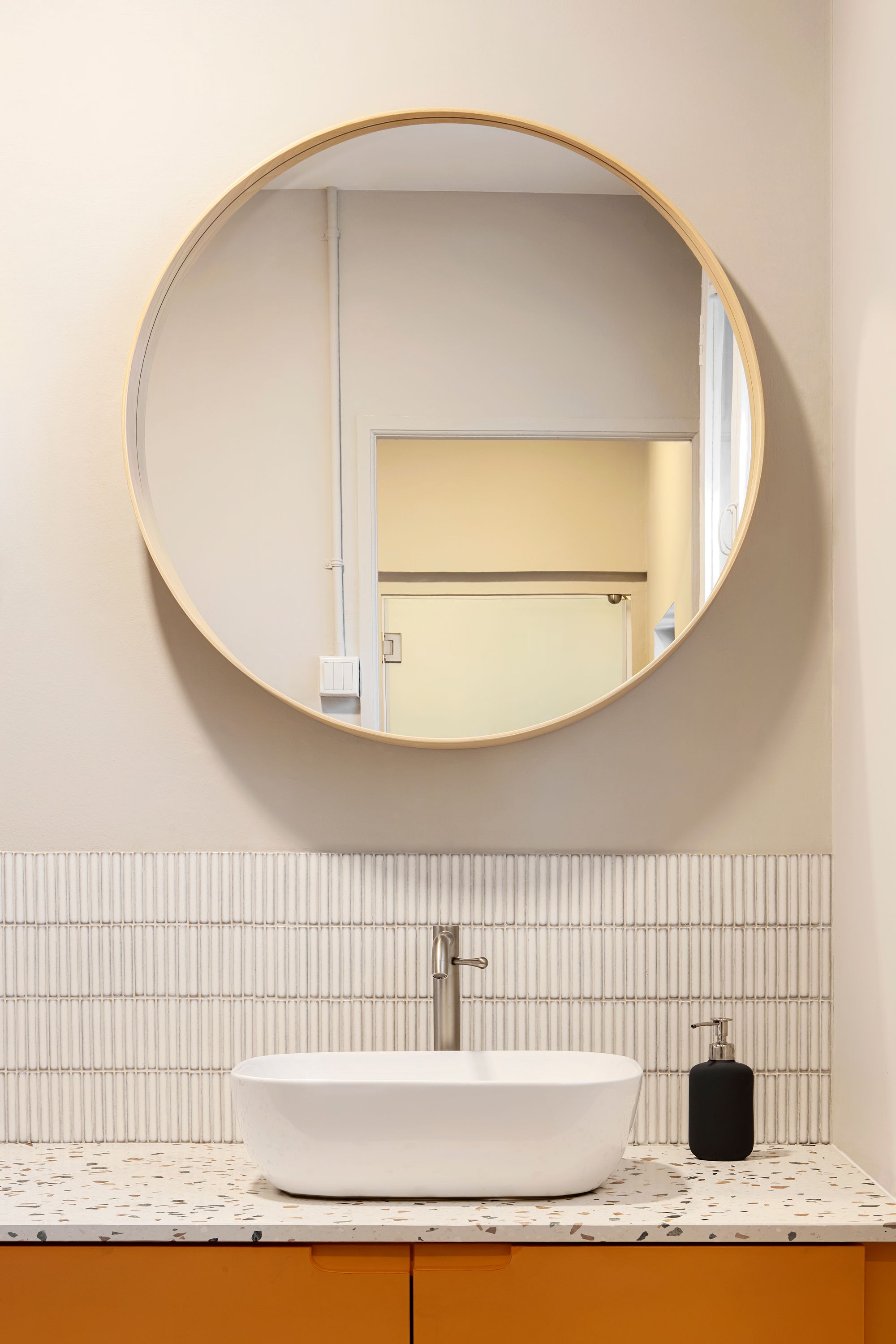 Round mirror in a pilates studio, by Shan Wong